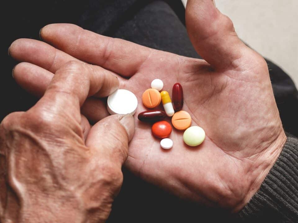 A lot of tablets in hands of the Senior